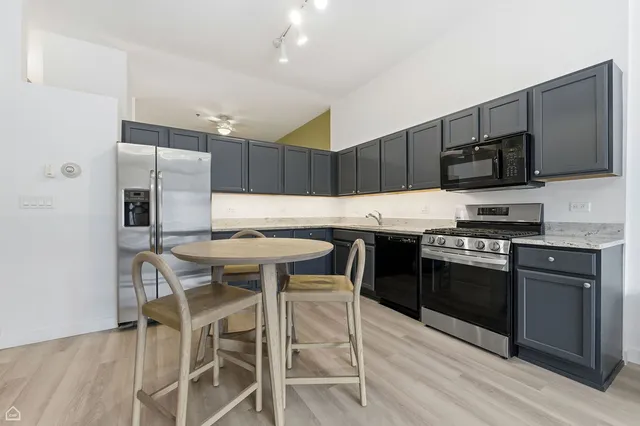 a kitchen with a table and chairs in it