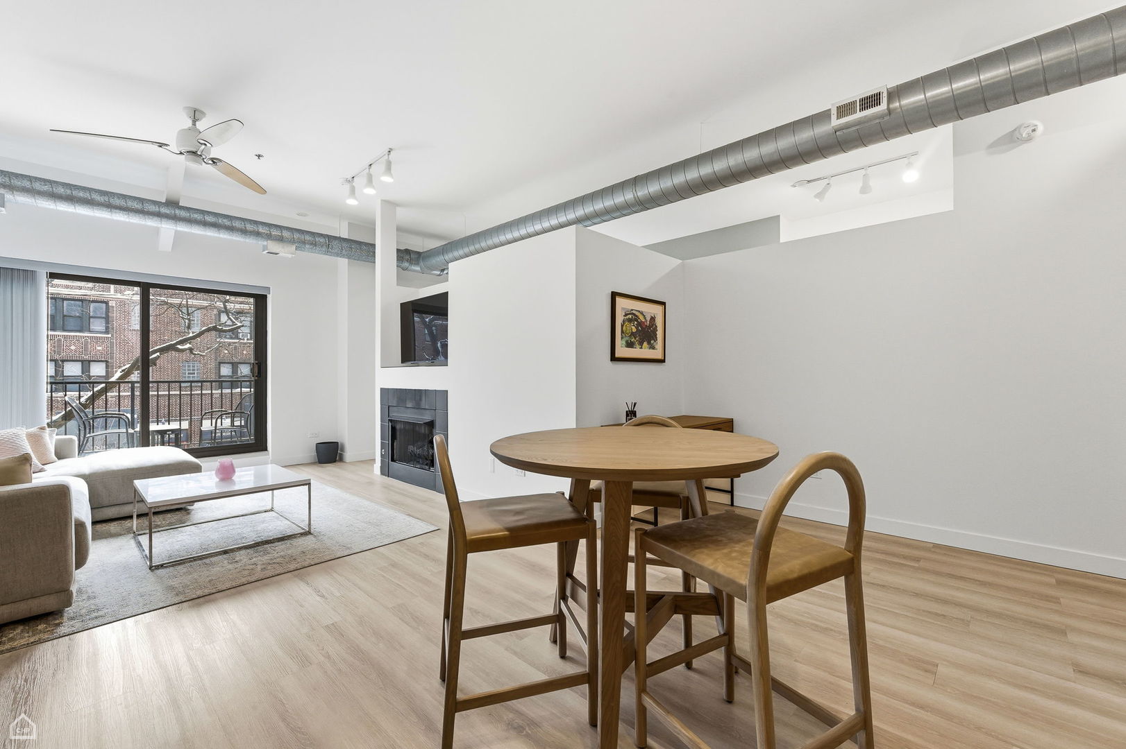 1000 East 53rd Street, Unit 215 Chicago, IL 60615 - Photo 5 of 17 a view of a dining room with furniture and wooden floor