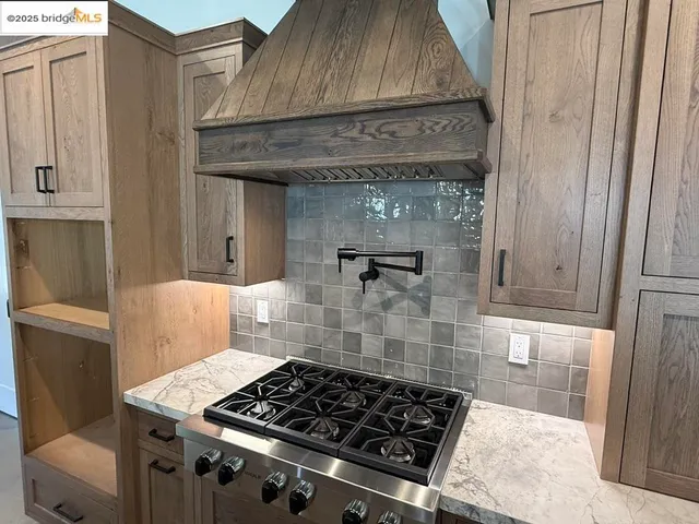 a kitchen with wooden cabinets and a stove top oven