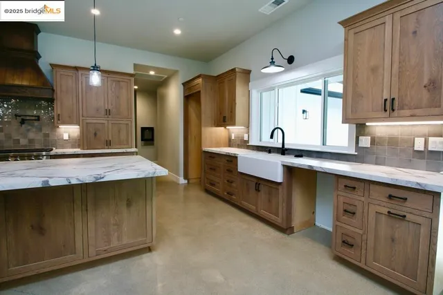 a bathroom with double vanity and a mirror