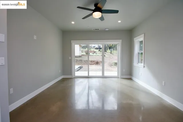 an empty room with windows and outdoor view