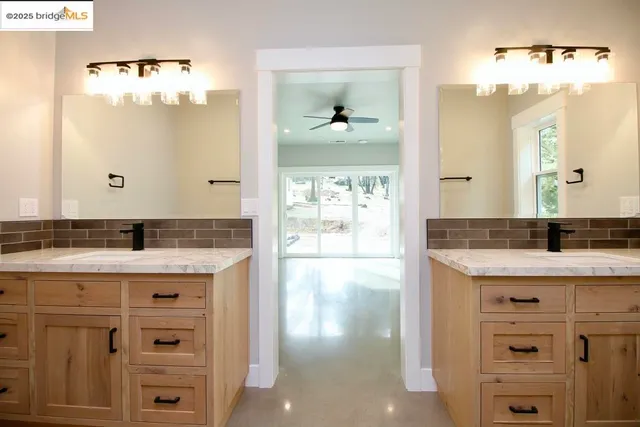 a bathroom with a sink vanity and a mirror