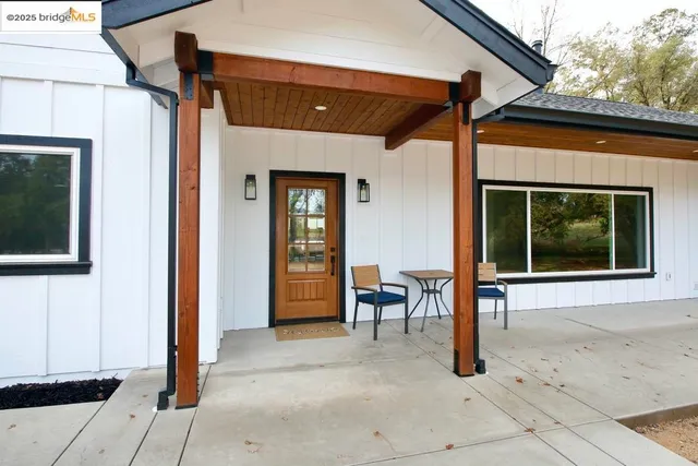 a front view of a house with outdoor seating