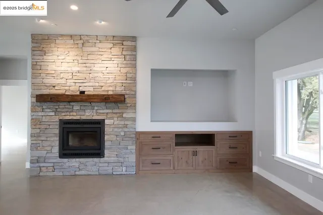 a view of fireplace and window in the room