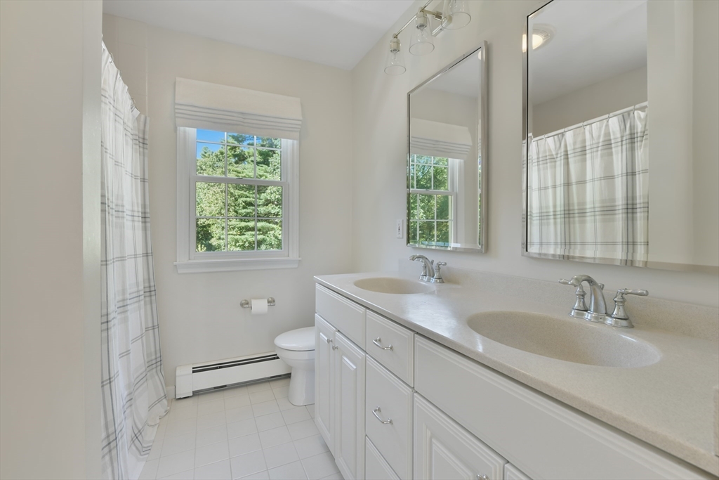 34 Valley Road Boxford, MA 01921 - Photo 22 of 42 a bathroom with a granite countertop toilet a sink and a window