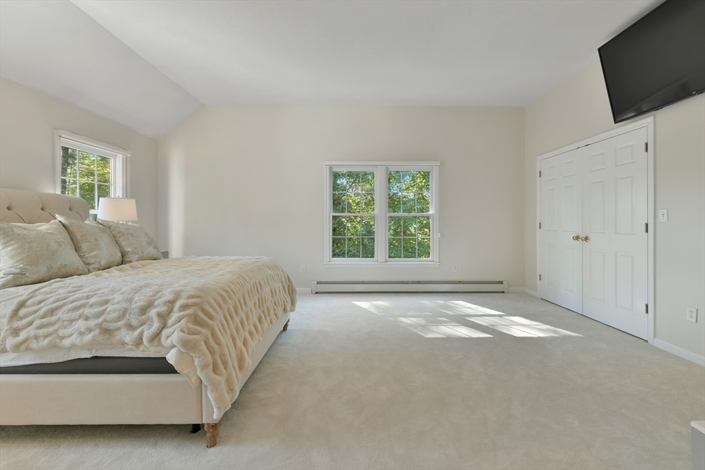 34 Valley Road Boxford, MA 01921 - Photo 28 of 42 a spacious bedroom with a bed and a flat screen tv