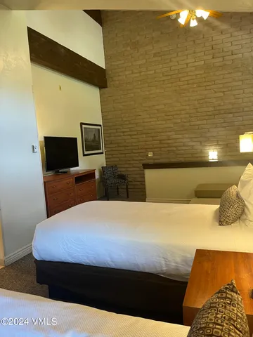 a bathroom with a granite countertop sink a mirror and a bathtub