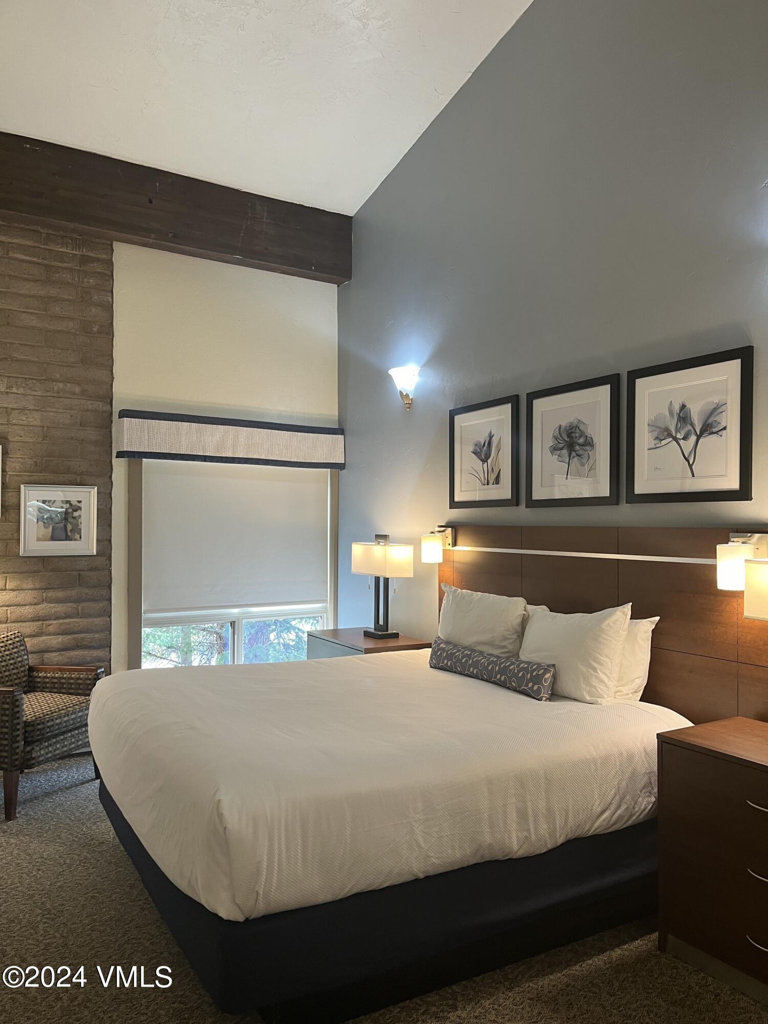 1020 Vail View Drive, Unit 340331 Vail, CO 81657 - Photo 5 of 25 a bedroom with a bed and painting on the wall