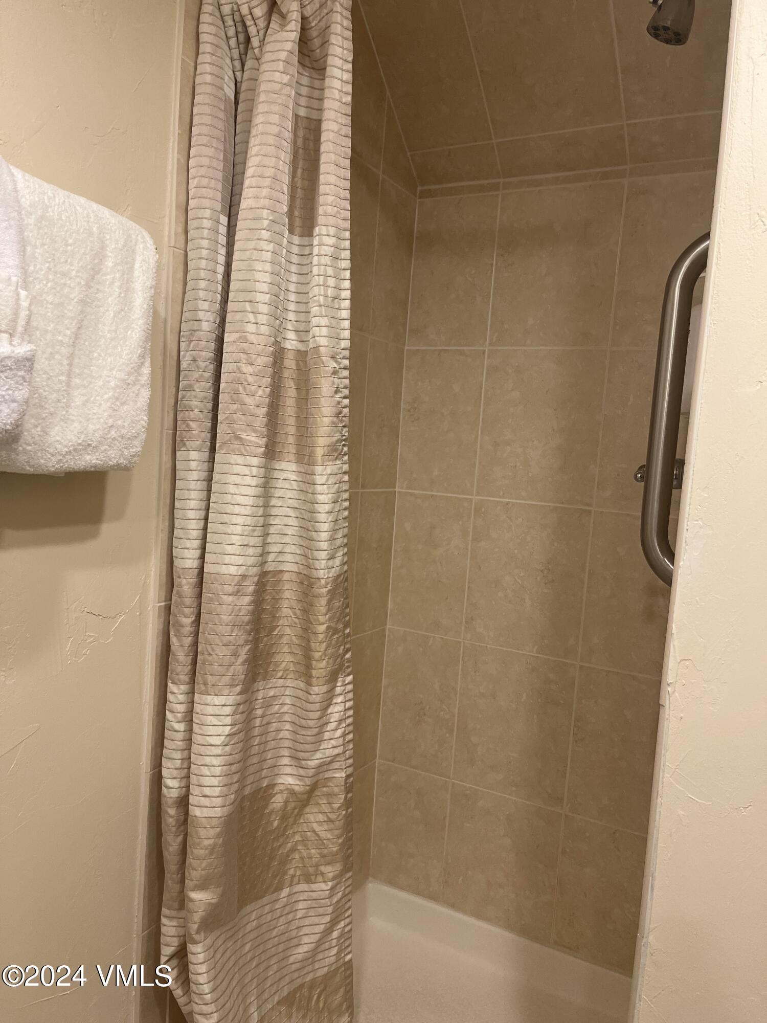 1020 Vail View Drive, Unit 340331 Vail, CO 81657 - Photo 8 of 25 a bathroom with a shower curtain and a sink