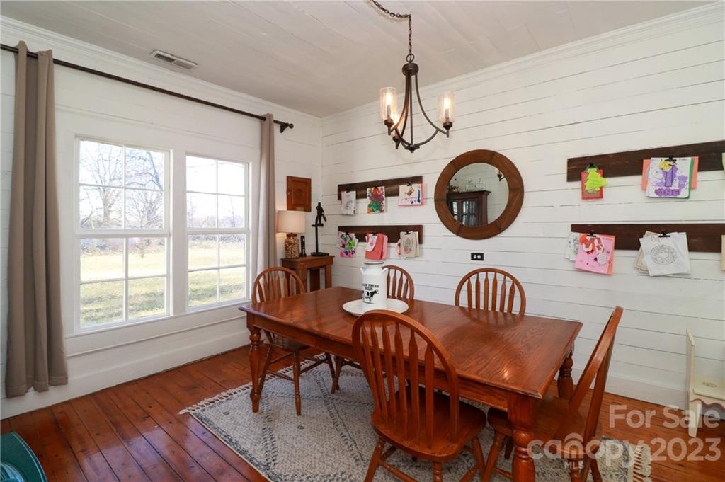8689 Math Road Stanfield, NC 28163 - Photo 11 of 36 a view of a dining room with furniture clock and wooden floor