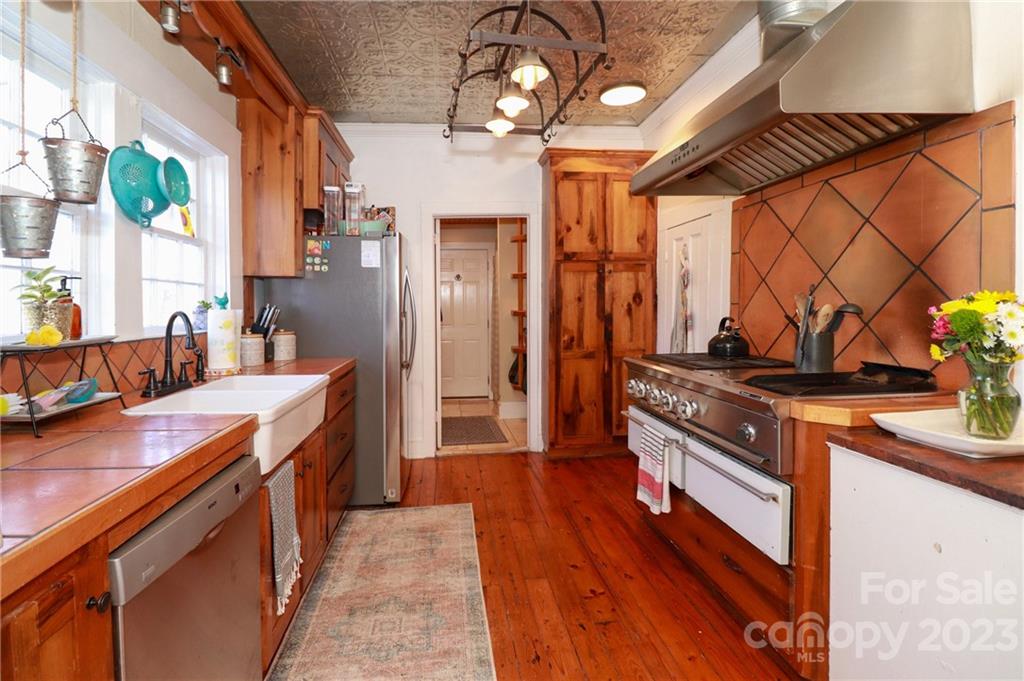 8689 Math Road Stanfield, NC 28163 - Photo 13 of 36 a kitchen with stainless steel appliances granite countertop a lot of counter space