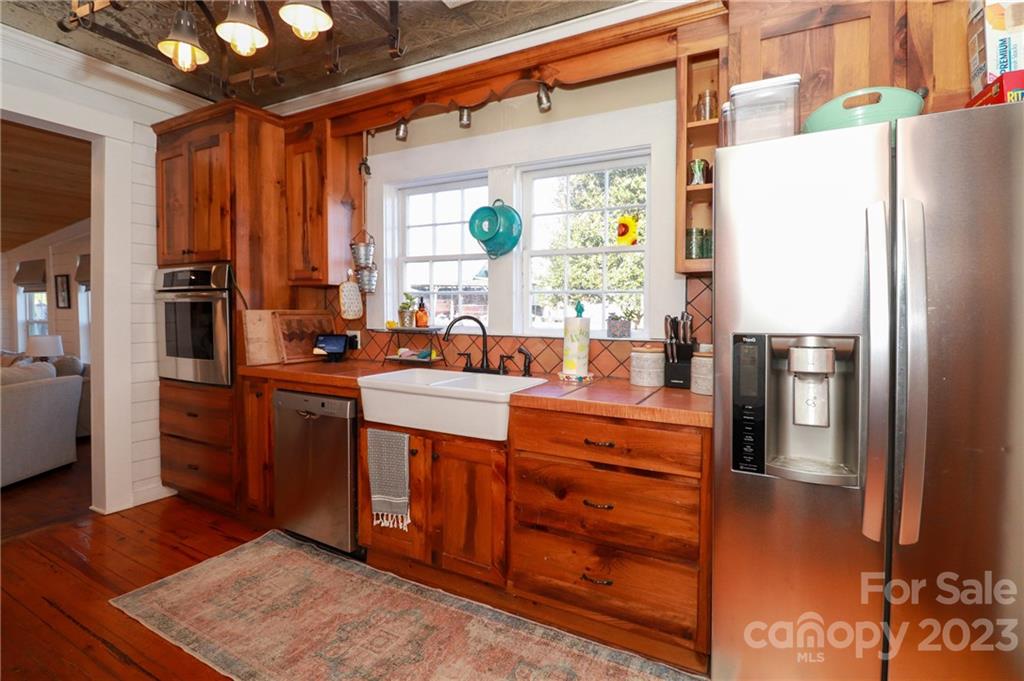 8689 Math Road Stanfield, NC 28163 - Photo 15 of 36 a kitchen with stainless steel appliances granite countertop a refrigerator and a sink