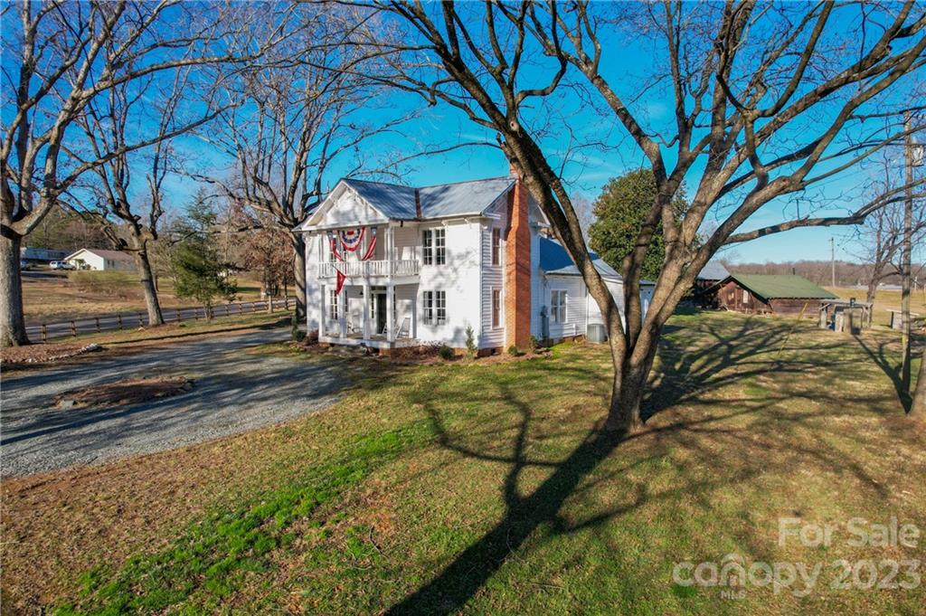 8689 Math Road Stanfield, NC 28163 - Photo 2 of 36 a view of a yard with large trees