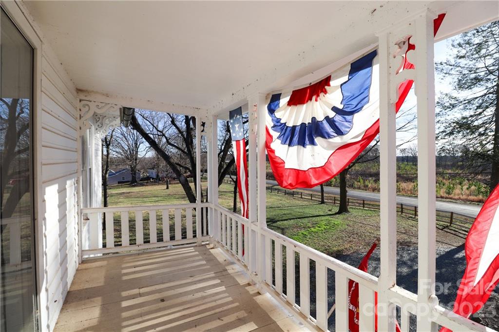 8689 Math Road Stanfield, NC 28163 - Photo 21 of 36 a view of a pathway with a sign on a wall