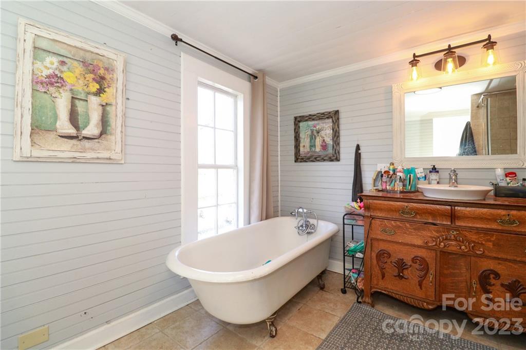 8689 Math Road Stanfield, NC 28163 - Photo 23 of 36 a bathroom with a bathtub sink and mirror