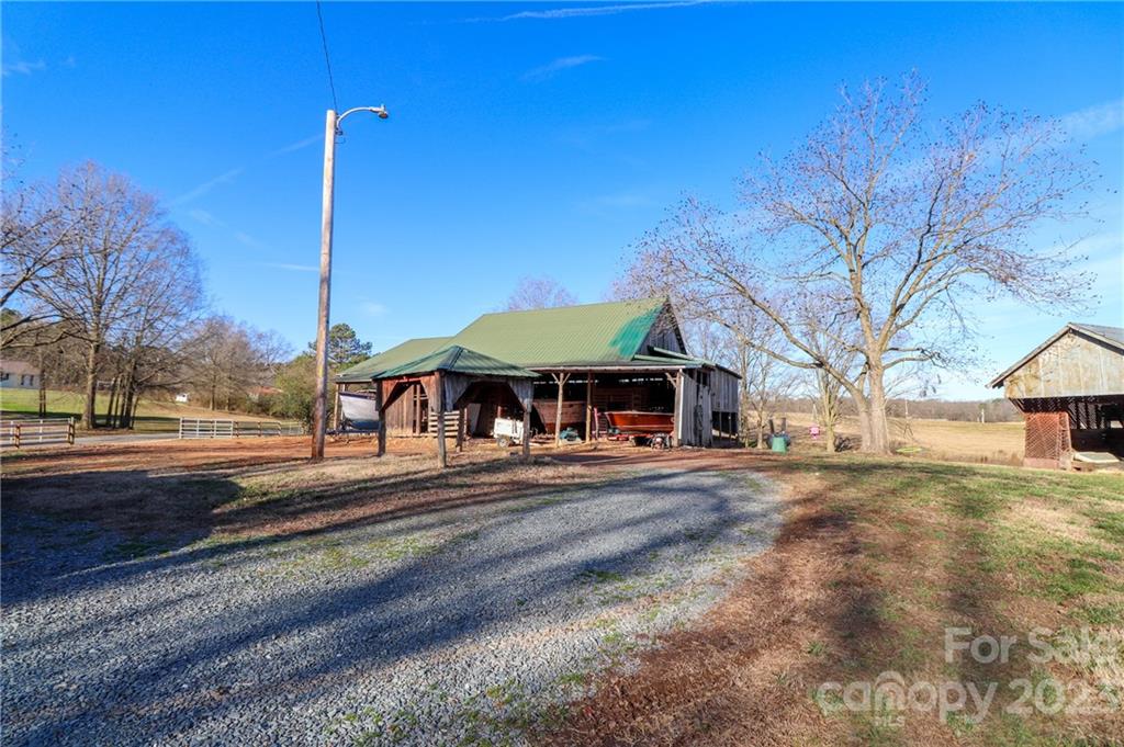 8689 Math Road Stanfield, NC 28163 - Photo 25 of 36 a front view of a house with a yard
