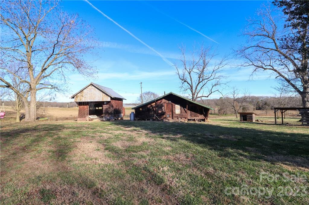 8689 Math Road Stanfield, NC 28163 - Photo 26 of 36 a wooden house with yard in front of it