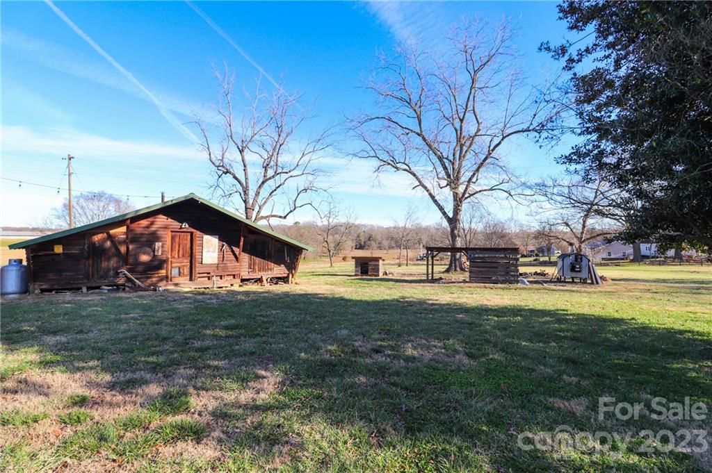8689 Math Road Stanfield, NC 28163 - Photo 27 of 36 a view of a house with a yard