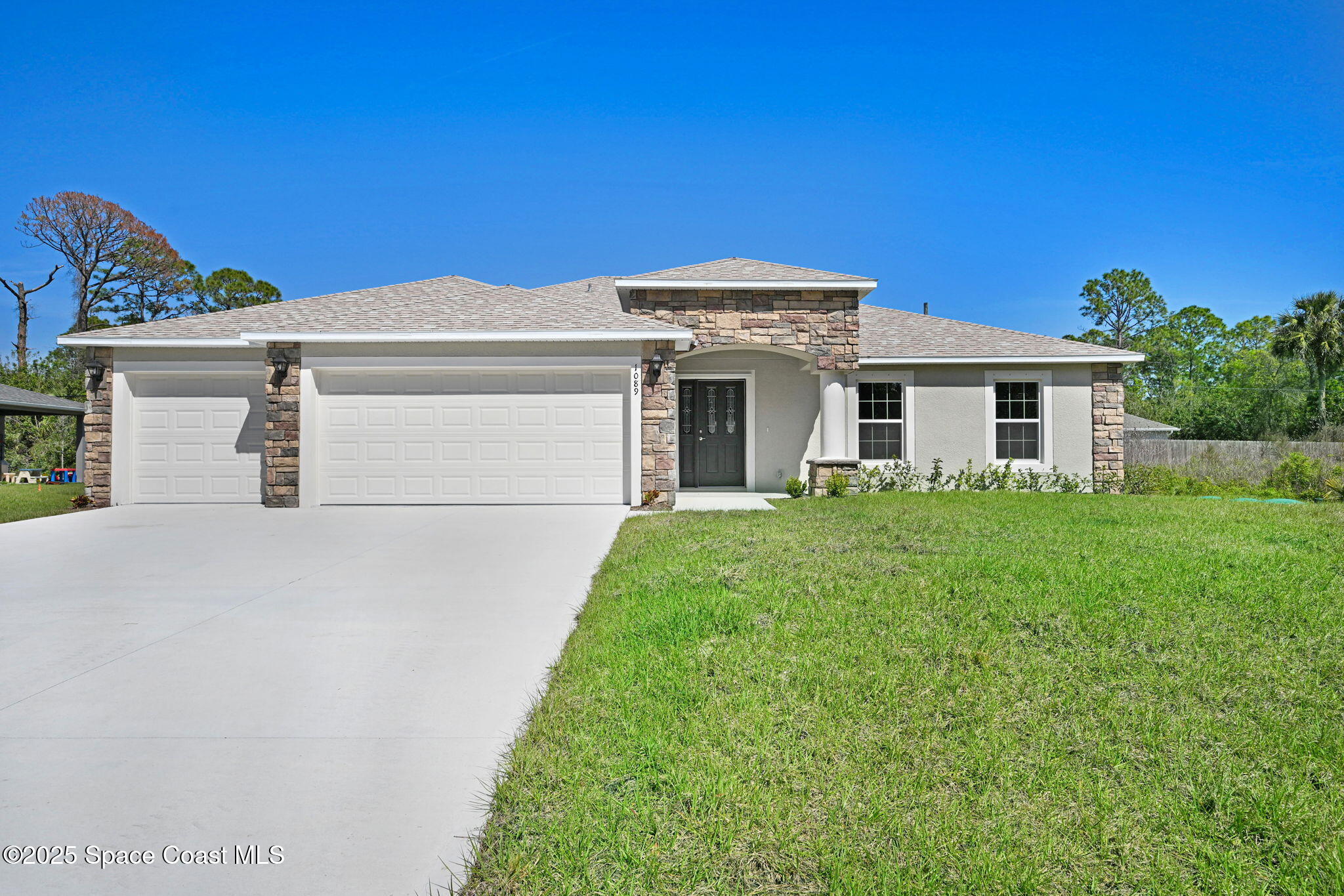 1089 Savery Road Palm Bay, FL 32908 - Photo 1 of 47 a front view of a house with a yard