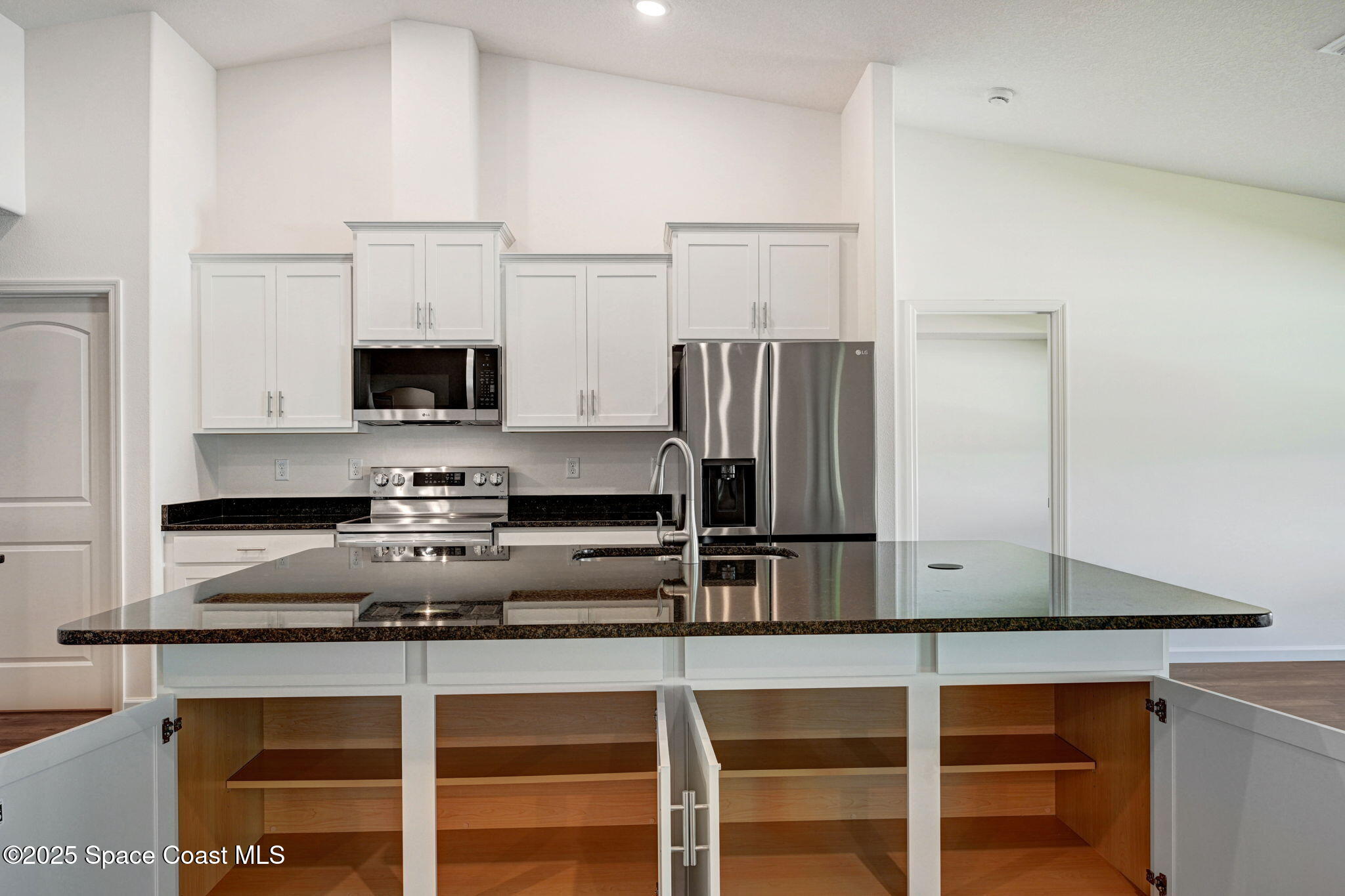 1089 Savery Road Palm Bay, FL 32908 - Photo 20 of 47 a kitchen with appliances a sink and cabinets