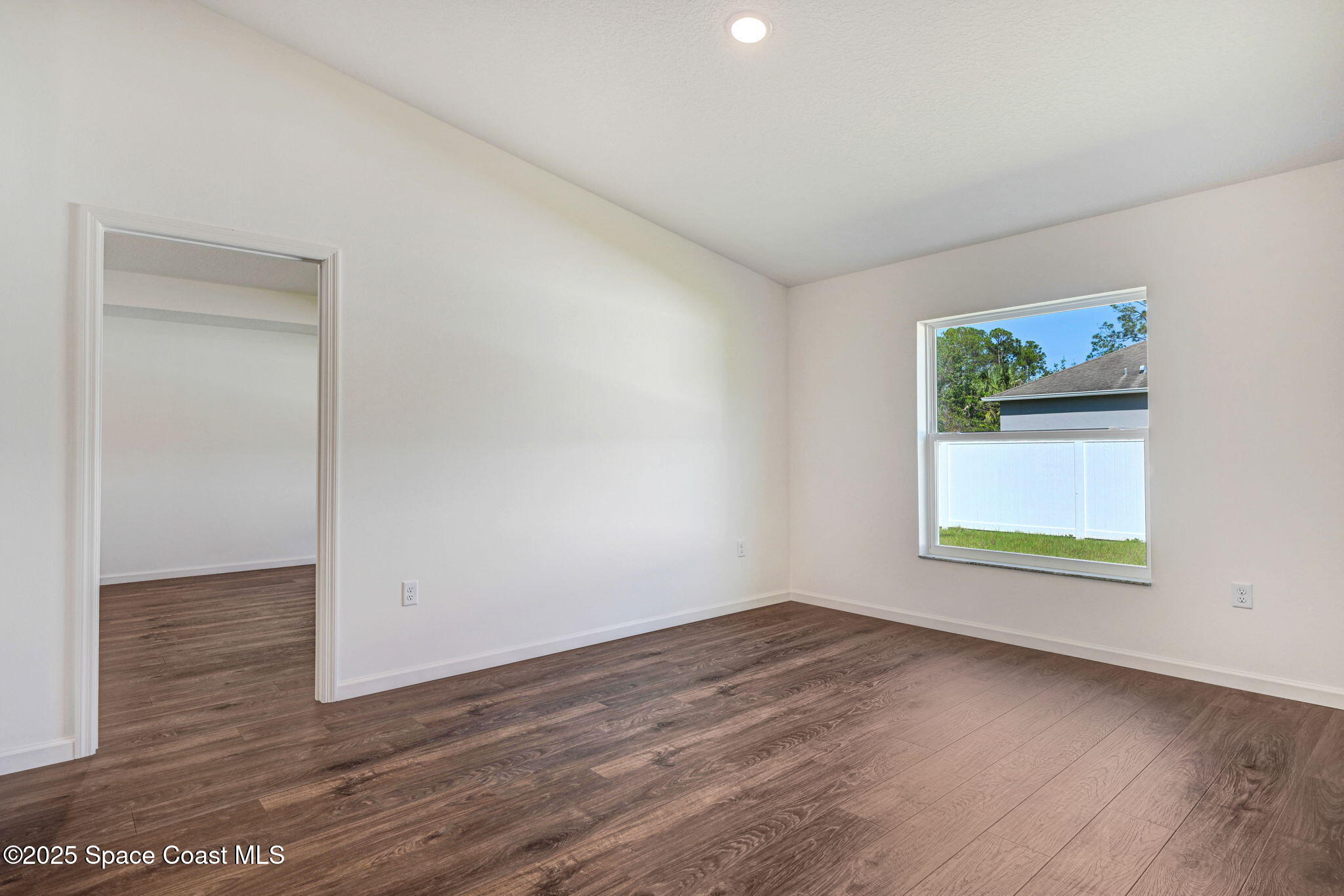 1089 Savery Road Palm Bay, FL 32908 - Photo 21 of 47 an empty room with wooden floor and window