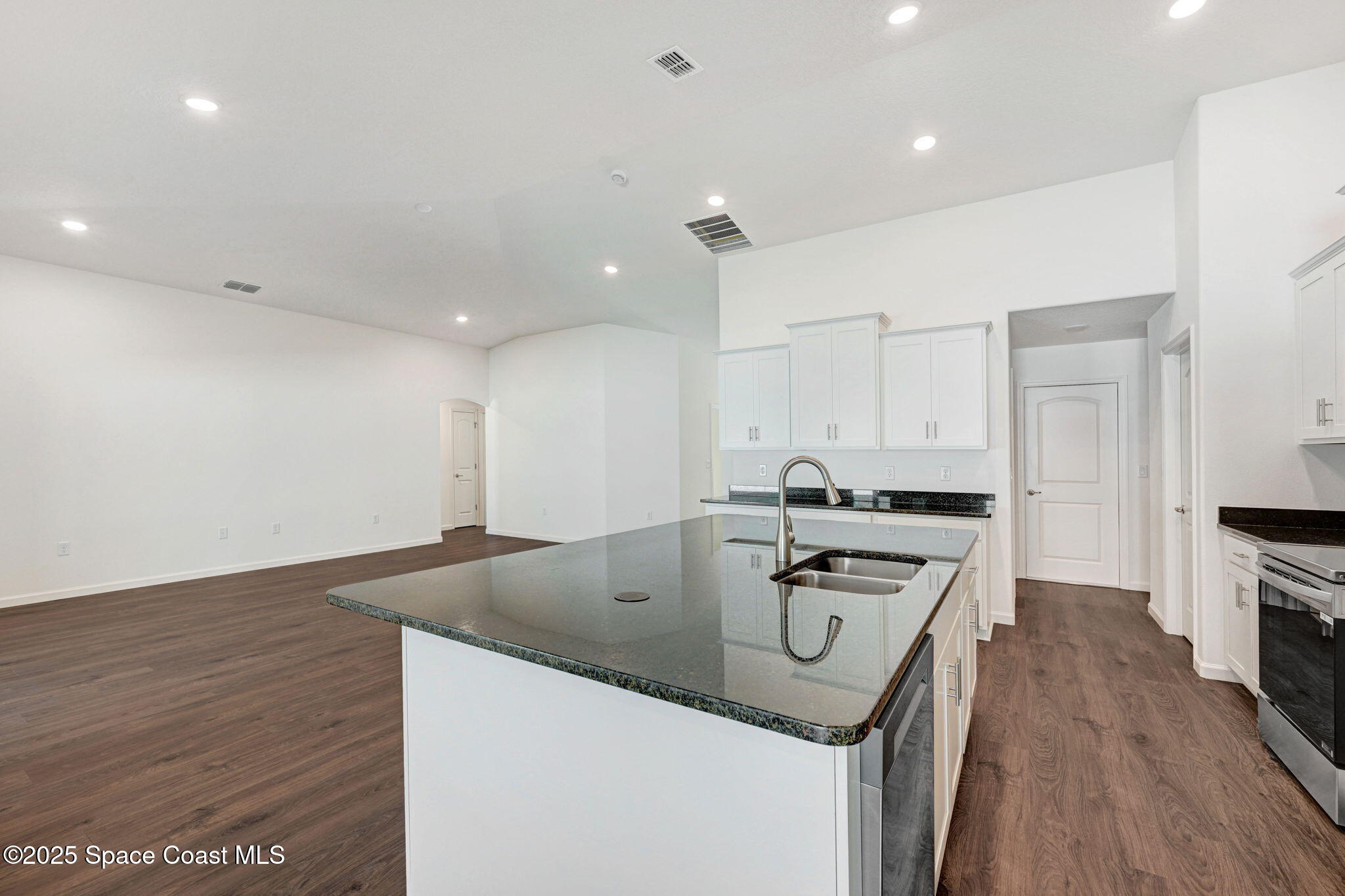 1089 Savery Road Palm Bay, FL 32908 - Photo 24 of 47 a kitchen that has a sink and a stove in it