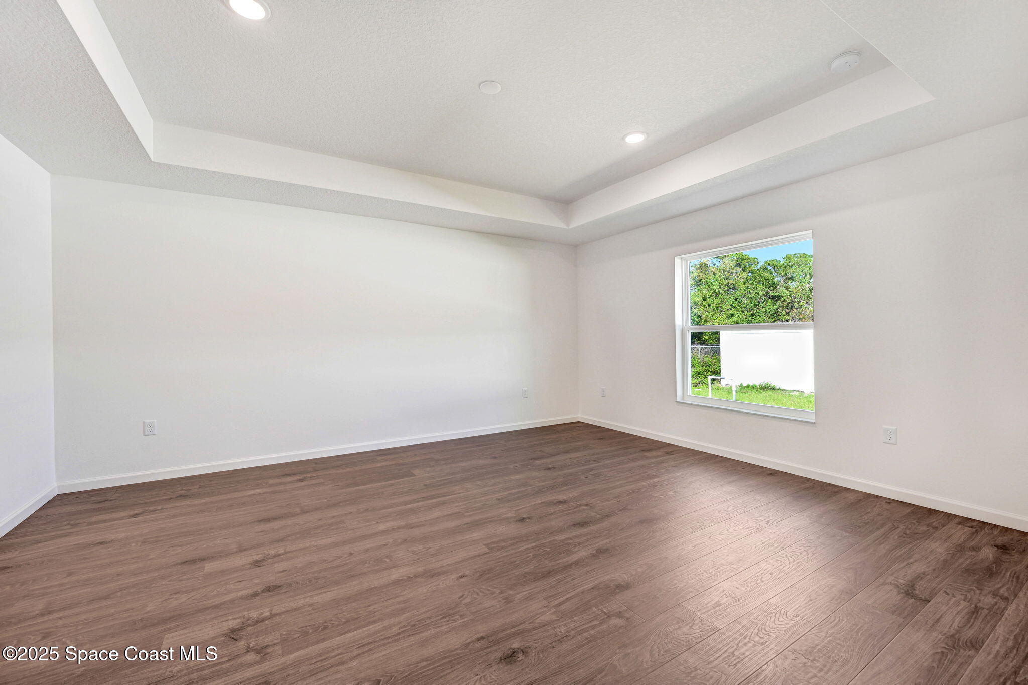 1089 Savery Road Palm Bay, FL 32908 - Photo 31 of 47 an empty room with wooden floor and windows