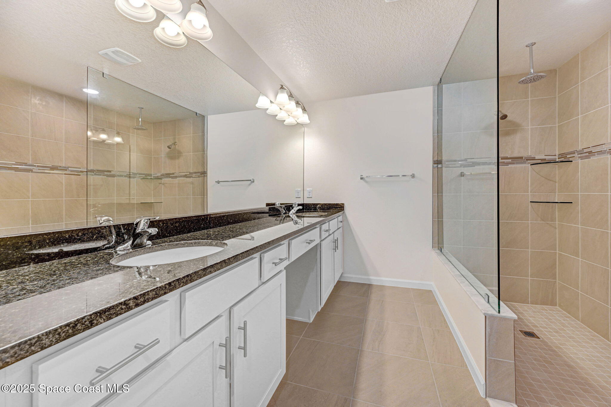 1089 Savery Road Palm Bay, FL 32908 - Photo 35 of 47 a large bathroom with a double vanity sink and a mirror