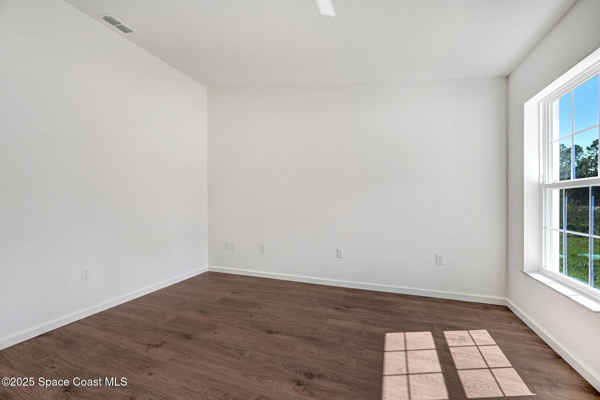 1089 Savery Road Palm Bay, FL 32908 - Photo 10 of 47 a view of empty room with wooden floor and fan