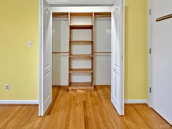 a view of room with window ceiling fan and wooden floor