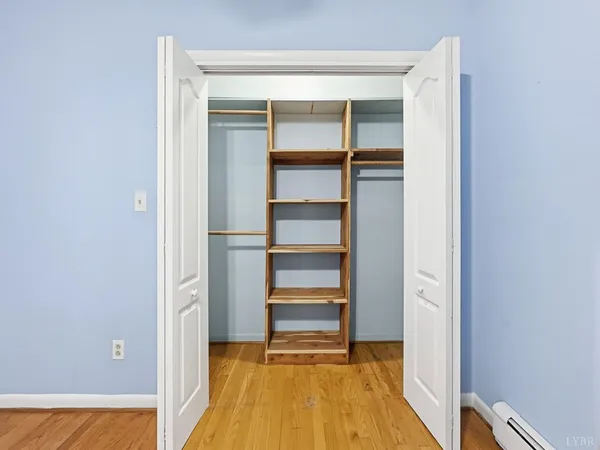 a view of a room with a window and a ceiling fan