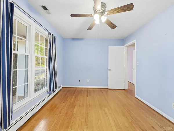 a empty room with a fireplace and fan