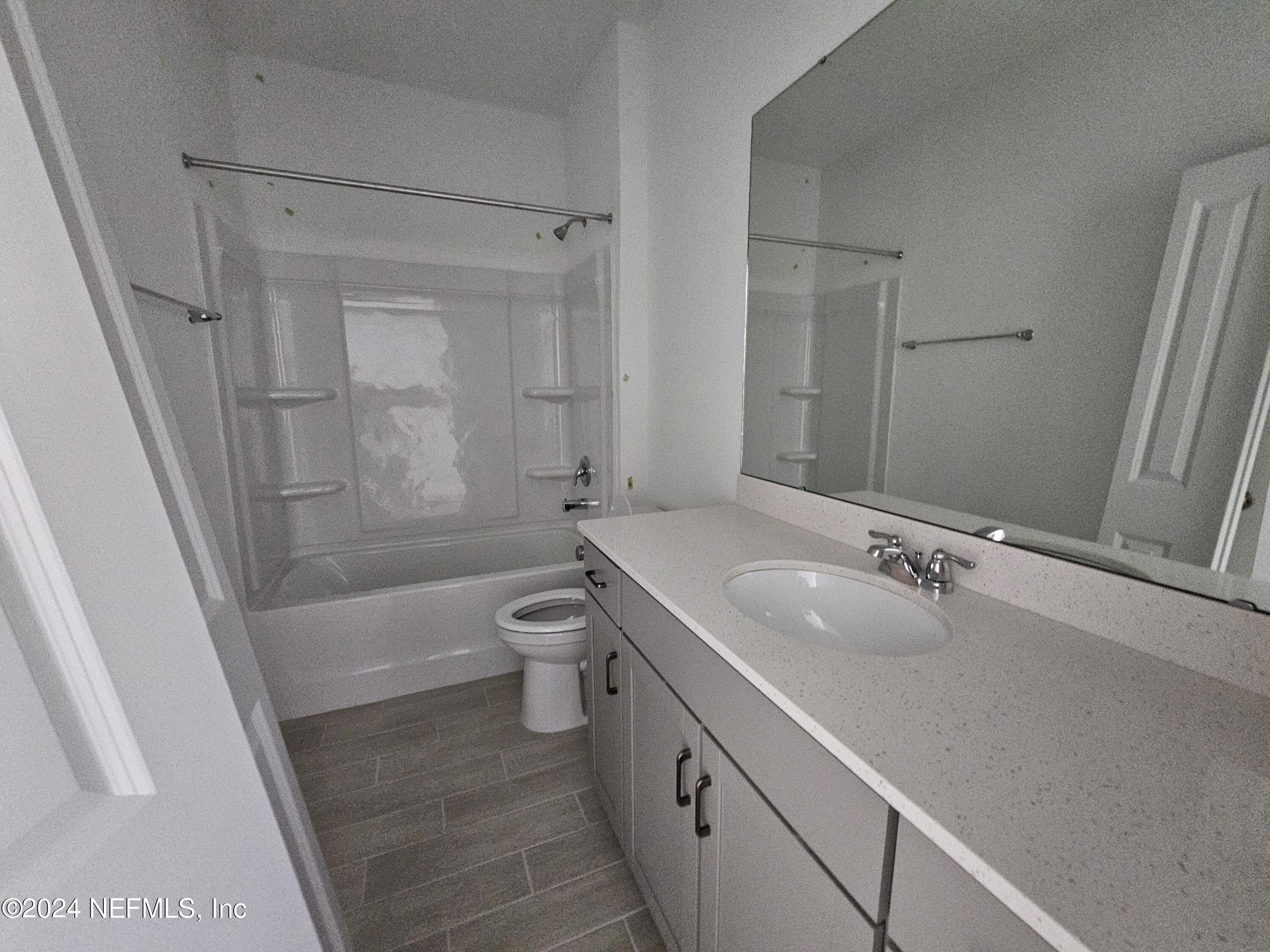 75232 Plumbago Trace Yulee, FL 32097 - Photo 15 of 79 a bathroom with a granite countertop sink toilet and shower