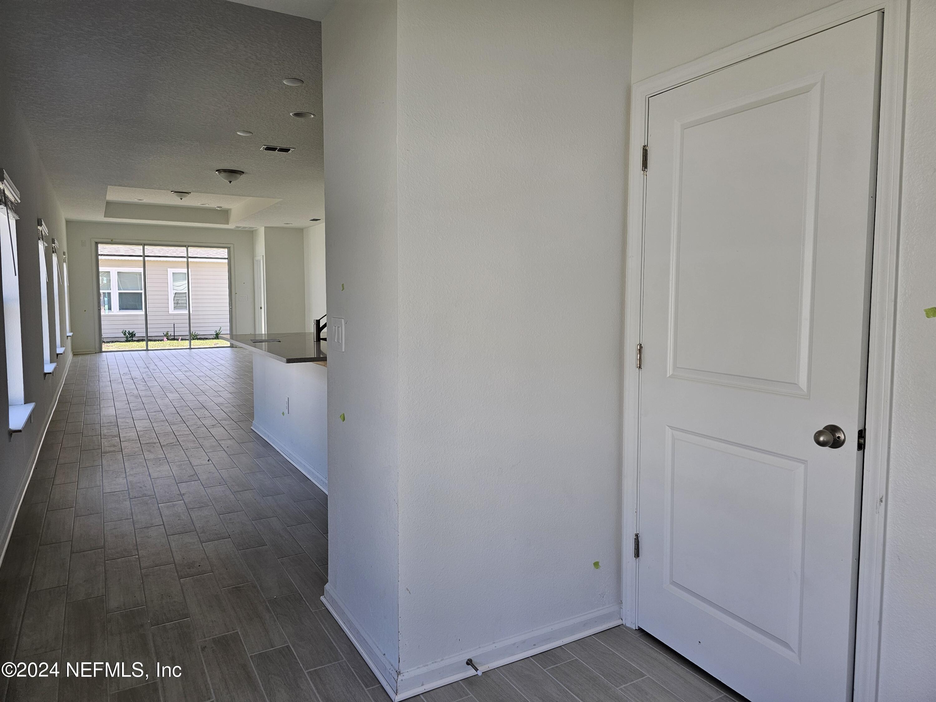 75232 Plumbago Trace Yulee, FL 32097 - Photo 3 of 79 a view of a hallway with wooden floor