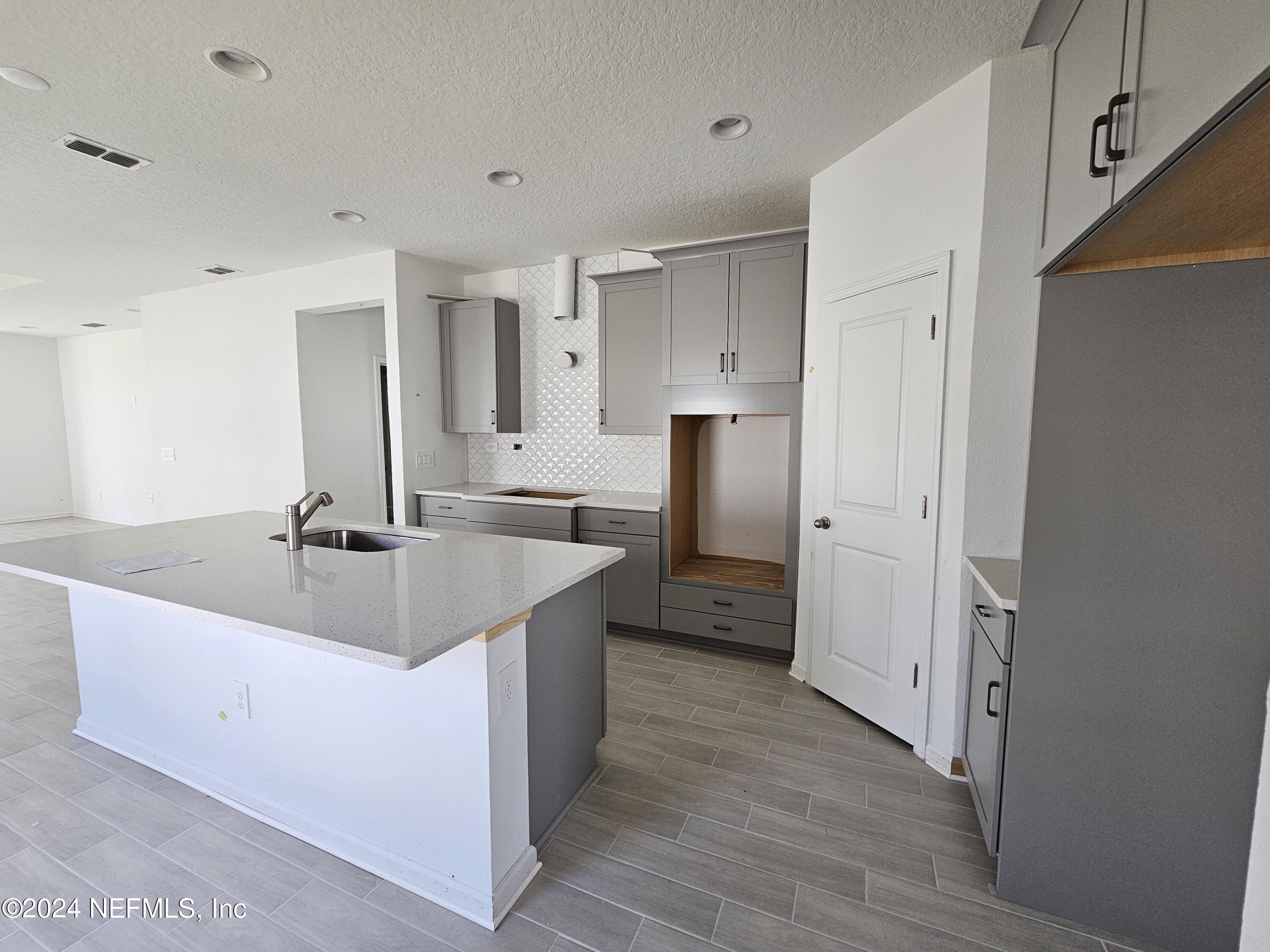 75232 Plumbago Trace Yulee, FL 32097 - Photo 4 of 79 a kitchen with a sink and a refrigerator