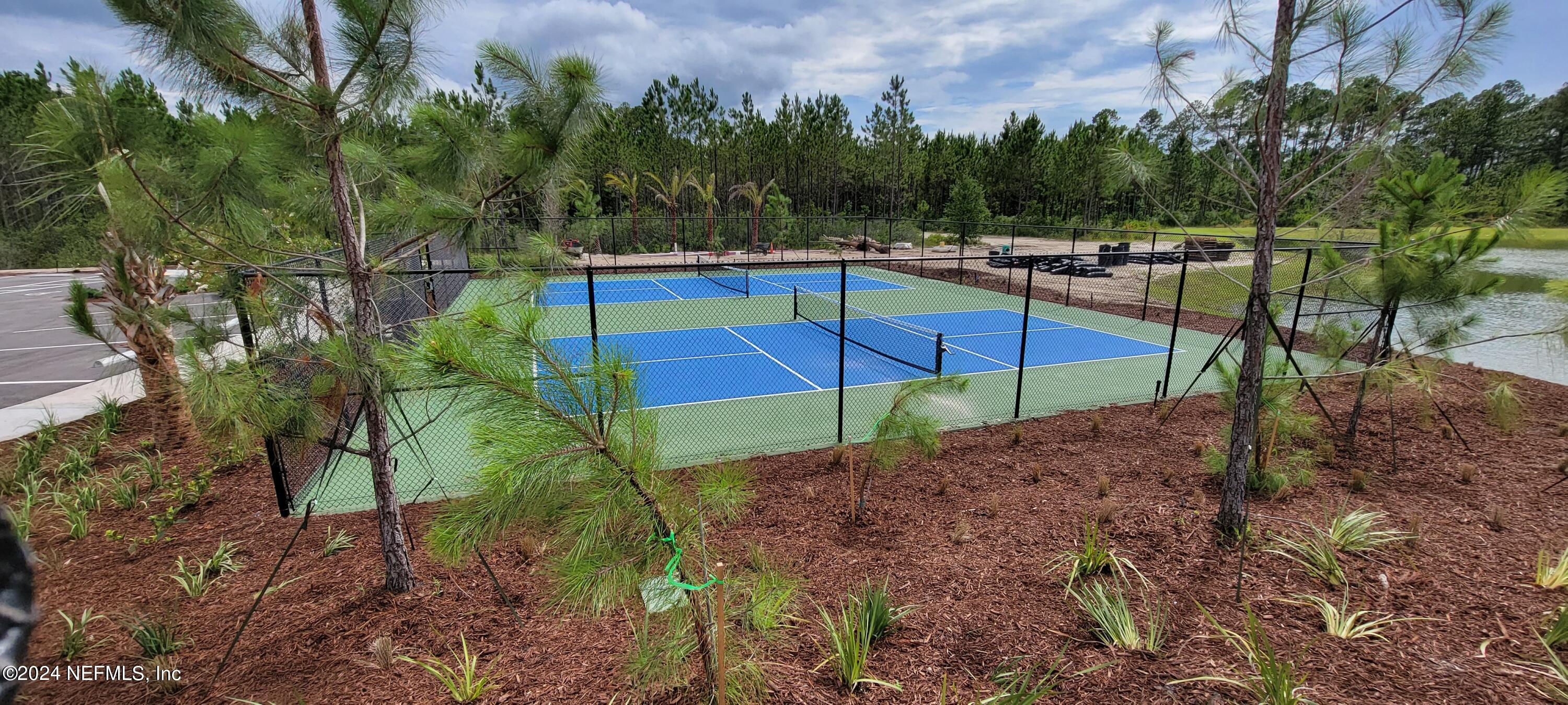 75232 Plumbago Trace Yulee, FL 32097 - Photo 66 of 79 a view of a backyard with sitting area