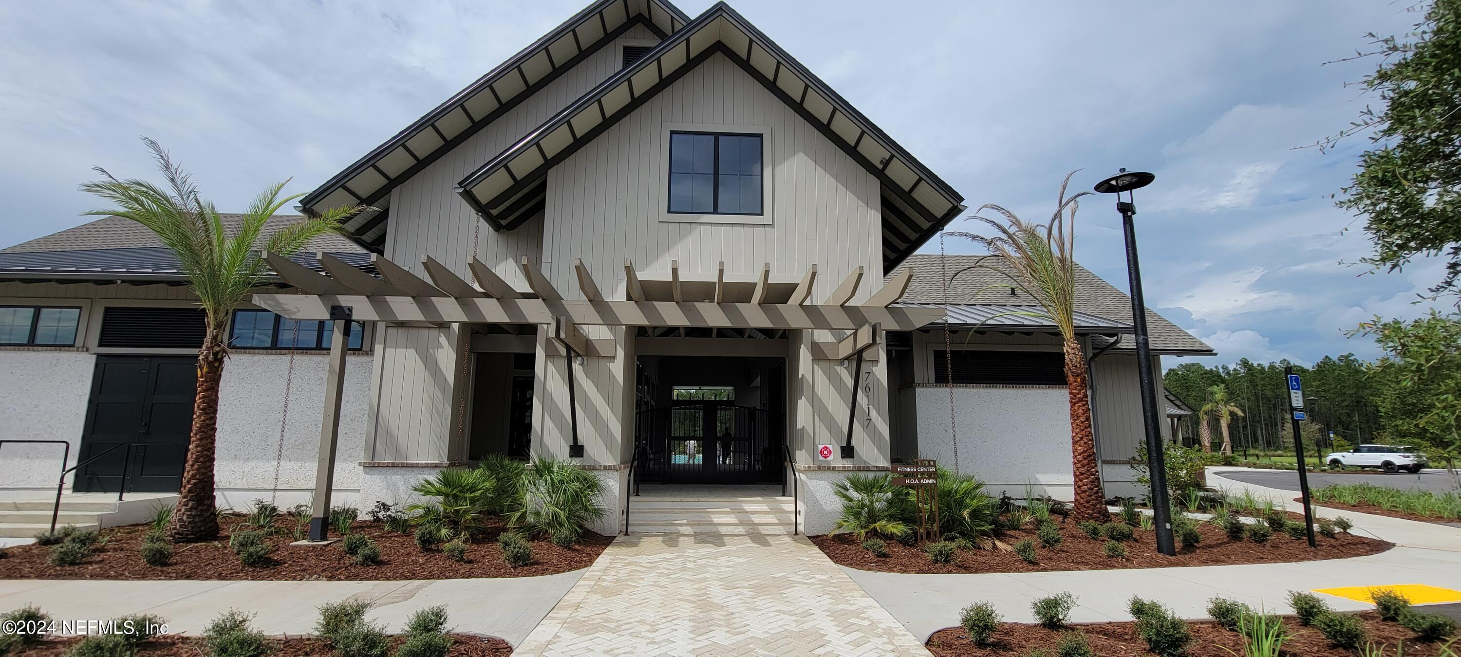 75232 Plumbago Trace Yulee, FL 32097 - Photo 70 of 79 a front view of a house with garden