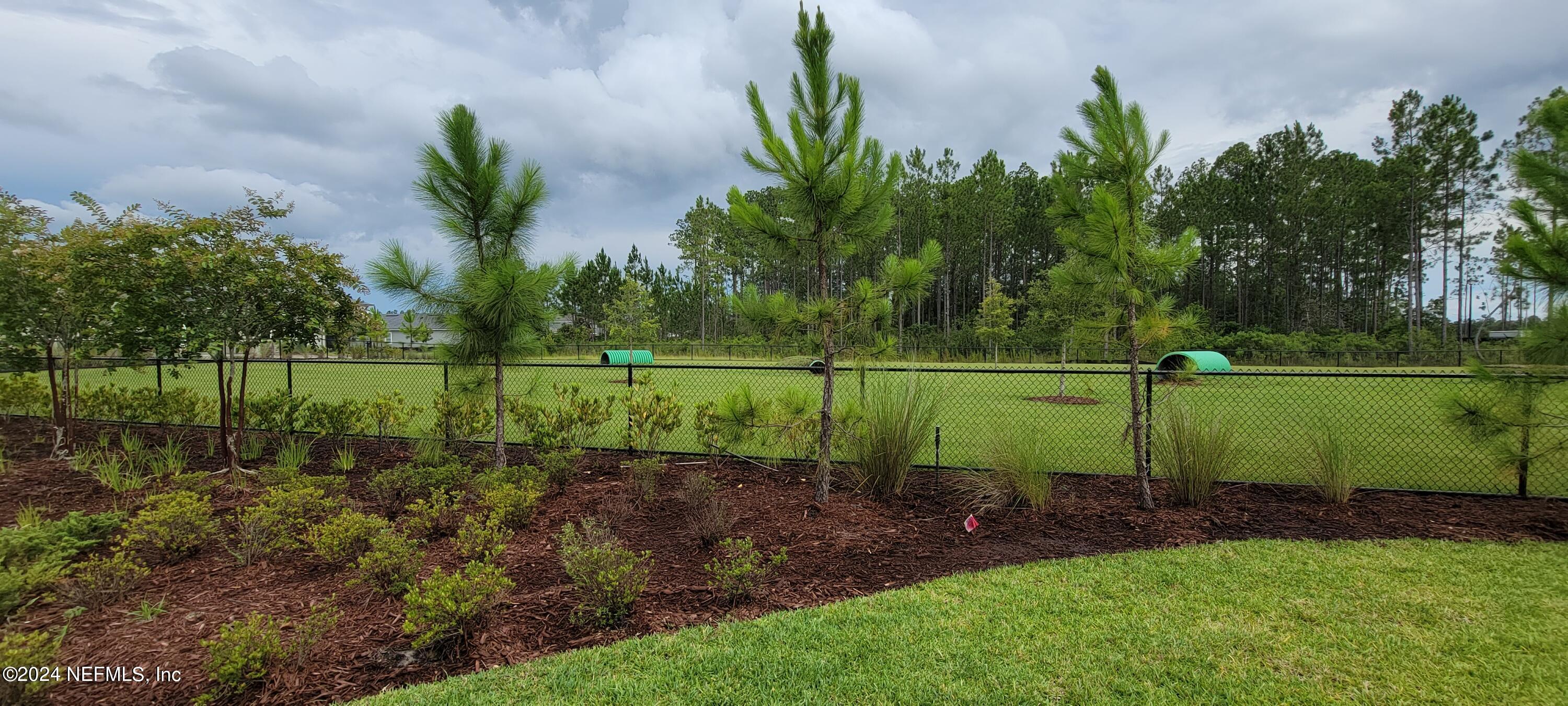 75232 Plumbago Trace Yulee, FL 32097 - Photo 75 of 79 a view of a park with a bench