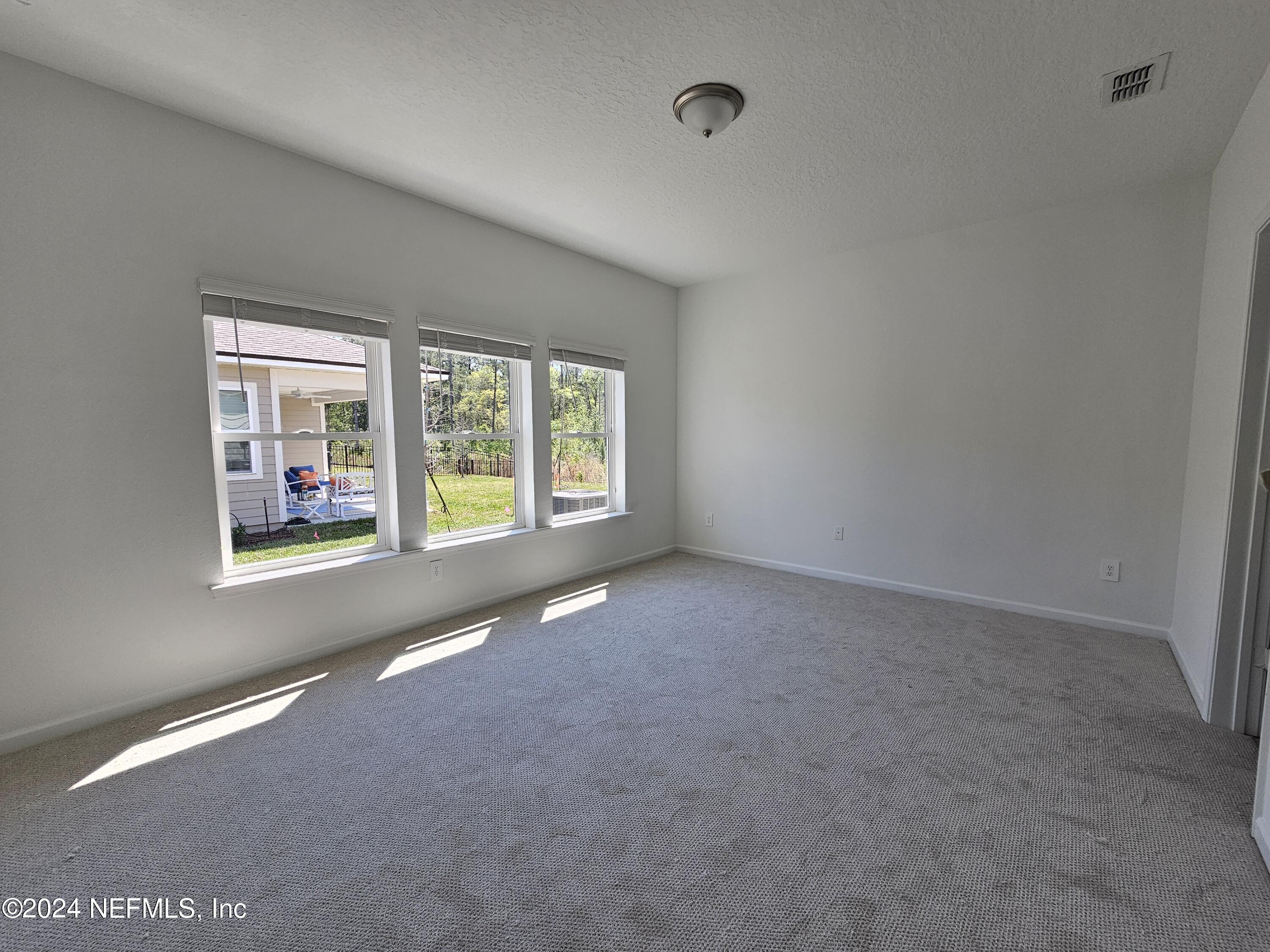 75232 Plumbago Trace Yulee, FL 32097 - Photo 8 of 79 an empty room with windows