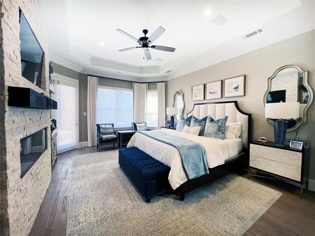 a spacious bedroom with a large bed and a fireplace