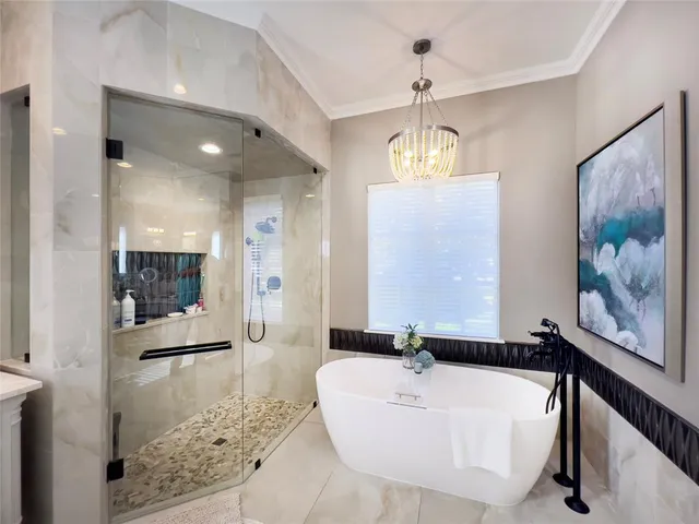 a spacious bathroom with a tub shower and window