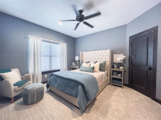 a bedroom with a large bed and a window