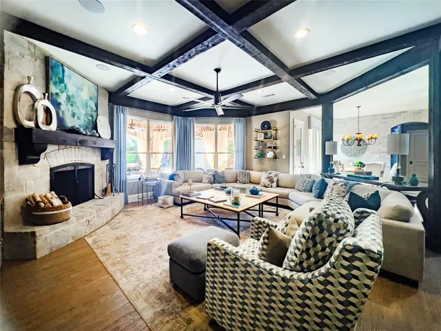 a living room with furniture fireplace and a large window