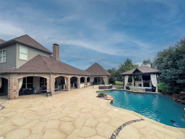 a front view of a house with a yard patio and lake view