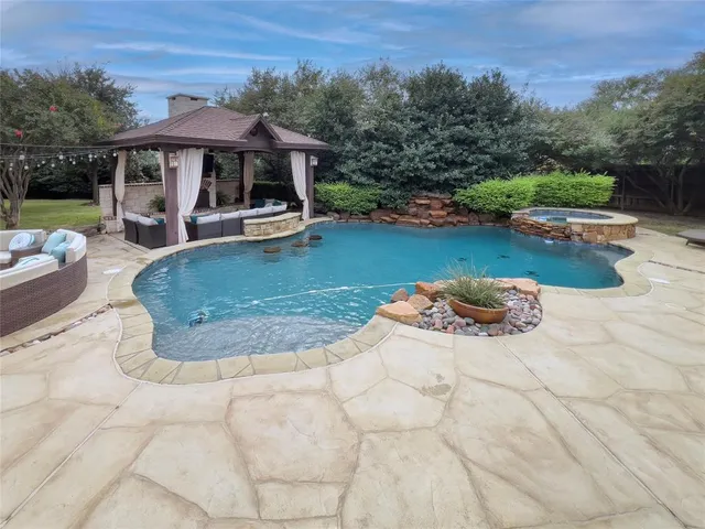 swimming pool view with a seating space