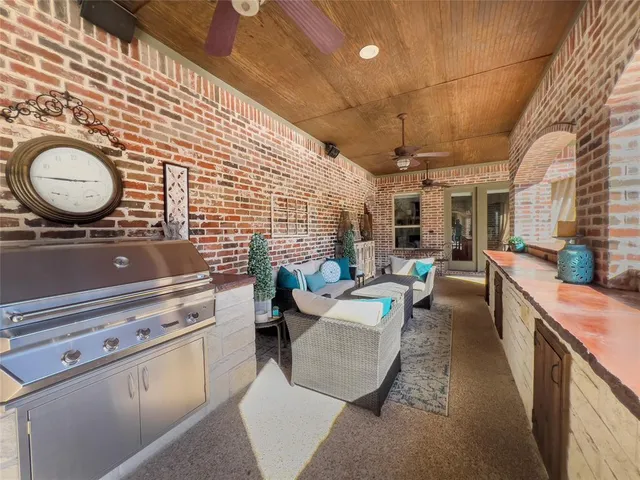 a living room with furniture a fireplace and a floor to ceiling window