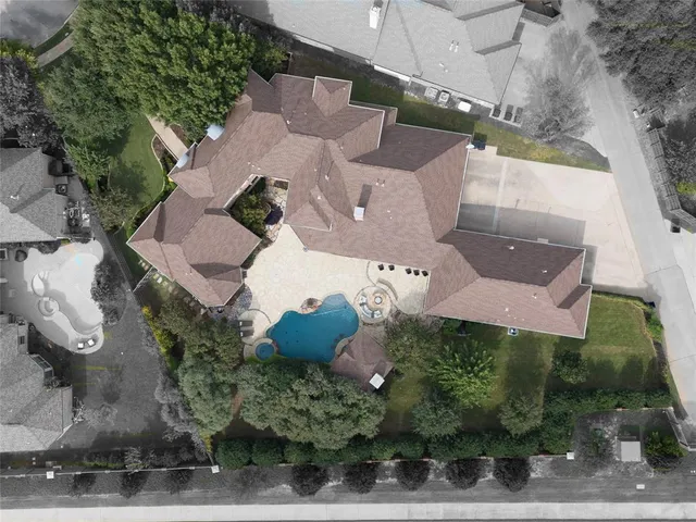 an aerial view of a house with a yard and a fountain