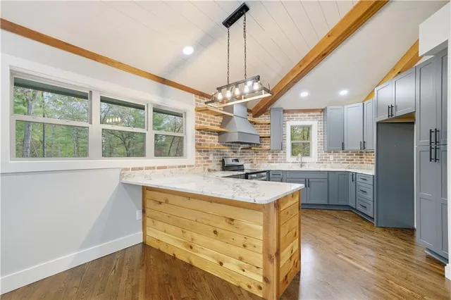 a kitchen with stainless steel appliances granite countertop a stove and a sink