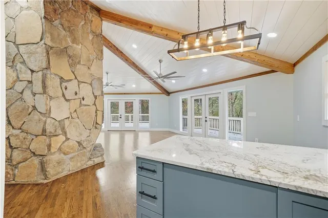 a spacious bathroom with a granite countertop sink and a mirror