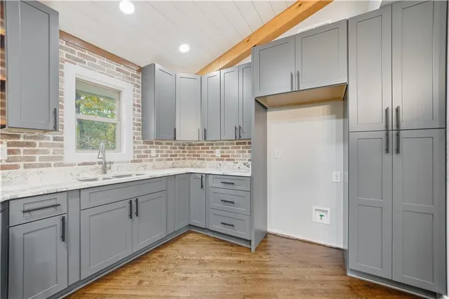 a bathroom with a granite countertop toilet sink mirror and vanity